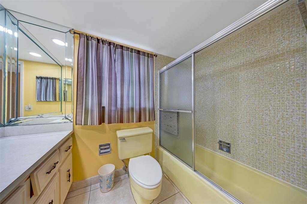 2681 South Course Drive, Unit 301 Pompano Beach, FL 33069 - Photo 18 of 27 a bathroom with a sink a toilet a mirror and shower