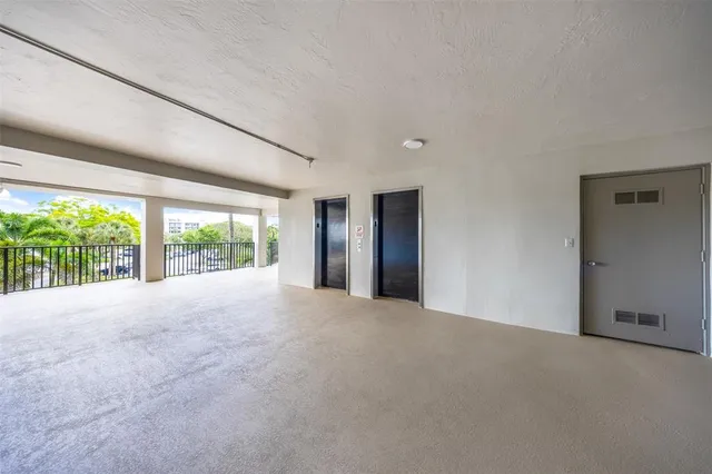 a view of an empty room with large windows