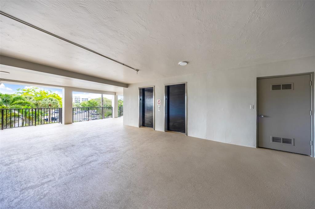 2681 South Course Drive, Unit 301 Pompano Beach, FL 33069 - Photo 25 of 27 a view of an empty room with large windows
