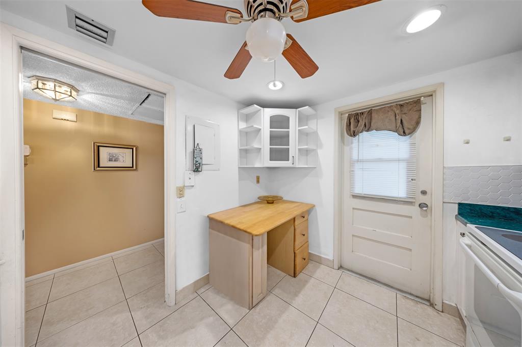 2681 South Course Drive, Unit 301 Pompano Beach, FL 33069 - Photo 3 of 27 a kitchen with stainless steel appliances granite countertop a refrigerator and a stove