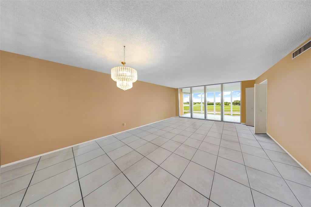 2681 South Course Drive, Unit 301 Pompano Beach, FL 33069 - Photo 4 of 27 a view of an empty room with a window