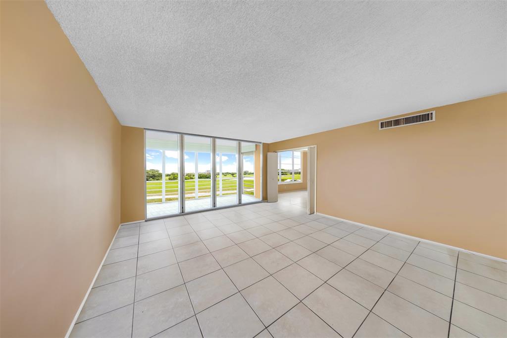 2681 South Course Drive, Unit 301 Pompano Beach, FL 33069 - Photo 6 of 27 a view of an empty room with a window