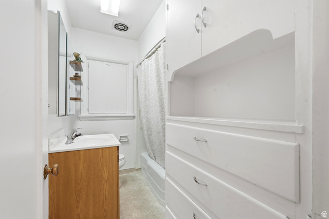 270 East 700 North Logan, UT 84321 - Photo 15 of 42 Bathroom with a wood-finish vanity, white sink, and chrome faucet