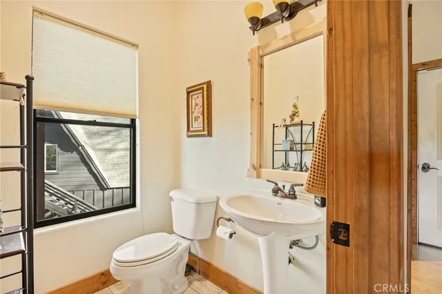 a bathroom with a toilet a sink and a mirror