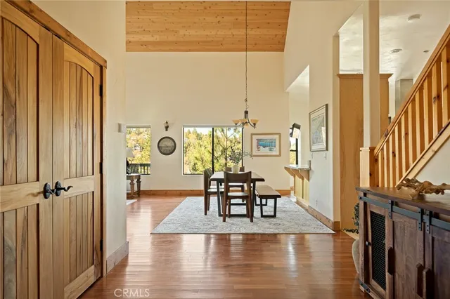 a view of a hallway with wooden floor fireplace and living room