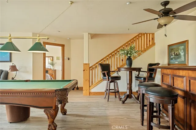 a room with pool table and windows