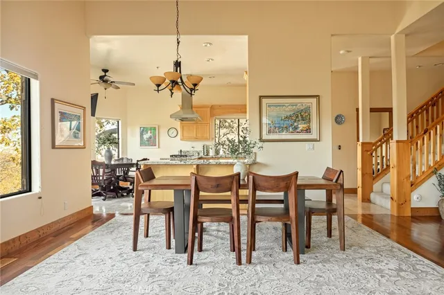 a view of a a dining room with furniture window and wooden floor