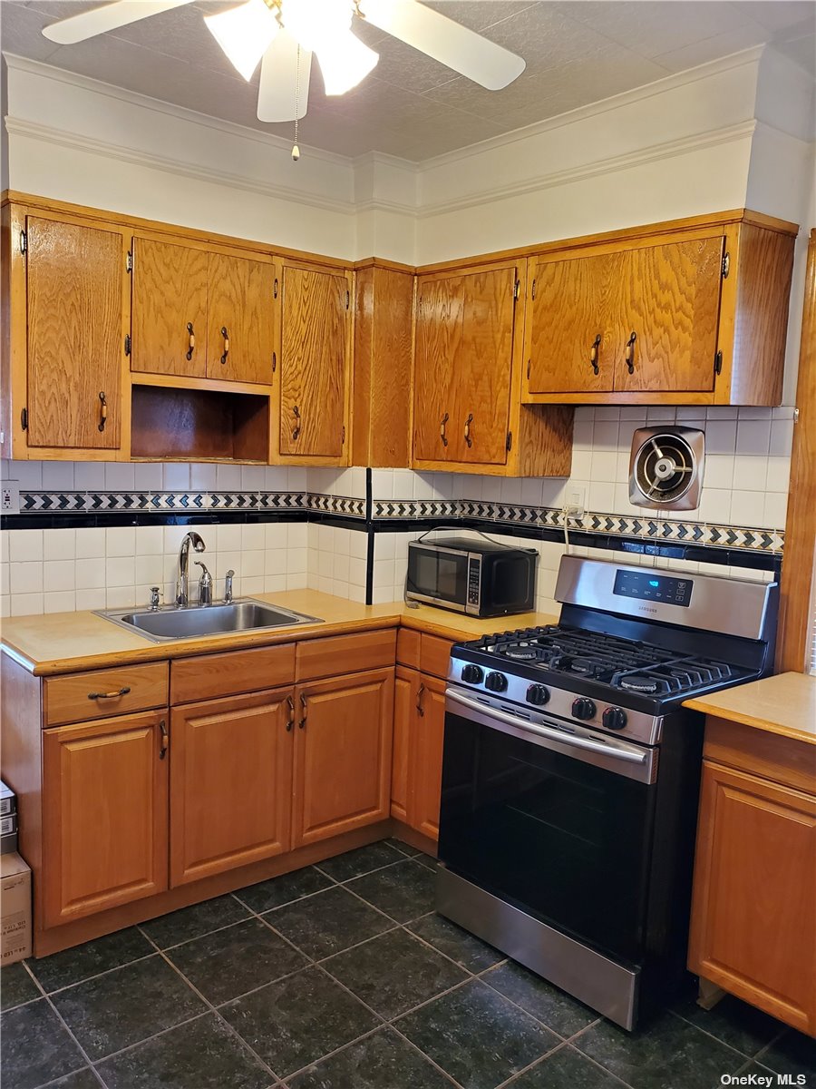 a kitchen with stainless steel appliances a stove a sink and a microwave