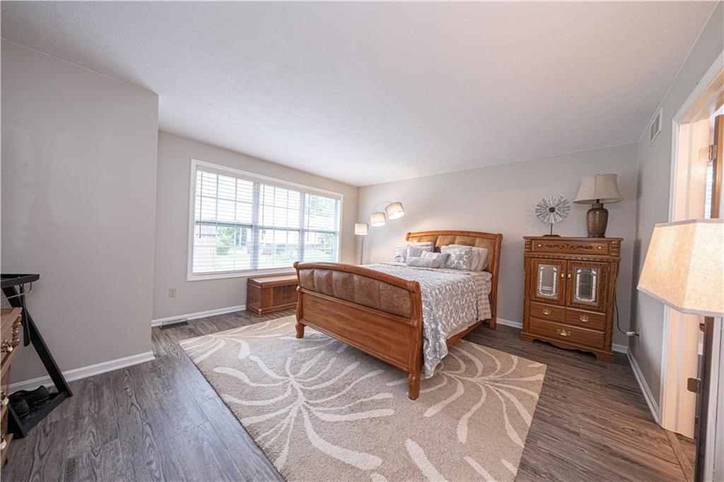 435 Cottage Lane Monroeville, PA 15146 - Photo 22 of 46 Second Owner's Suite featuring new LVP flooring and abundant natural light from triple front-facing windows.