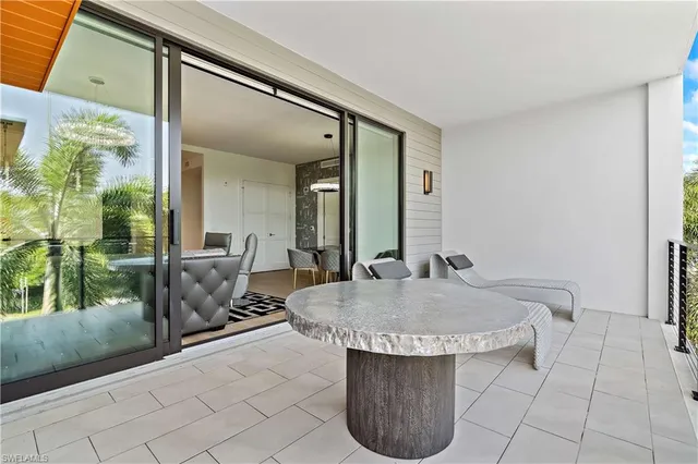 a room with pool table and outdoor seating