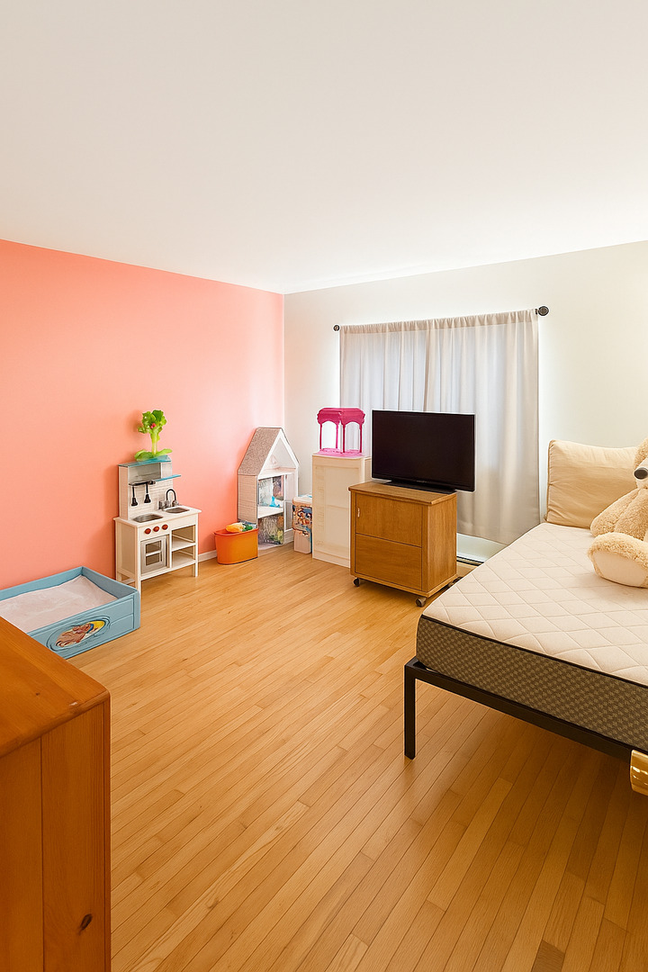 2139 North Harlem Avenue, Unit 224 Chicago, IL 60707 - Photo 12 of 18 a living room with furniture and a flat screen tv