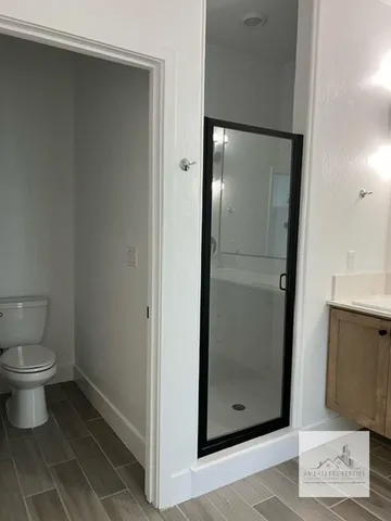 a bathroom with a toilet and a mirror