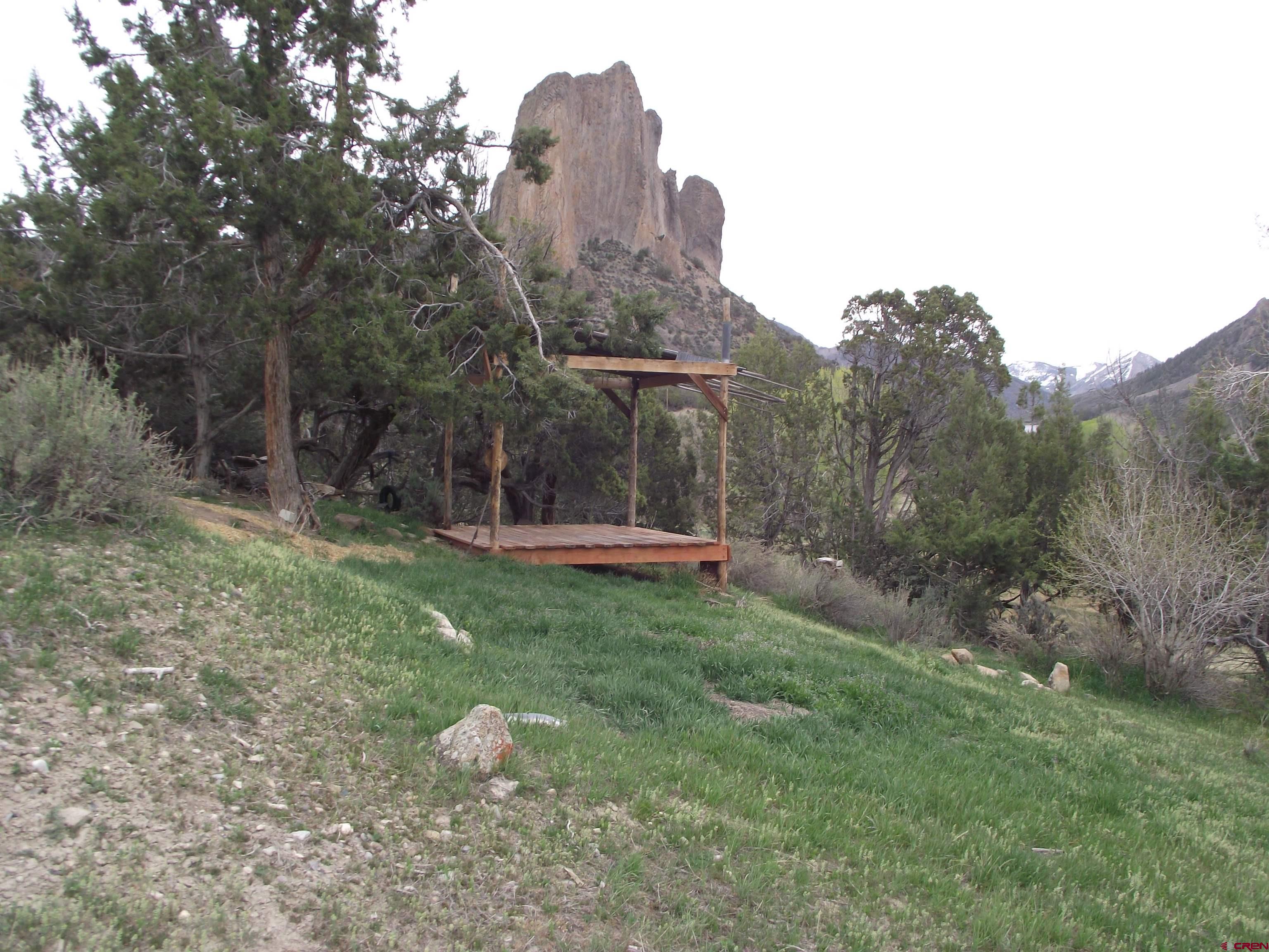 42996 Needle Rock Road Crawford, CO 81415 - Photo 17 of 45 a backyard of a house with table and chairs