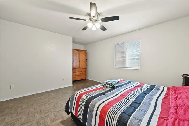 a bedroom with a bed and a chandelier