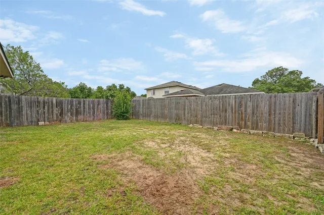 a bathroom with a small yard and wooden fence