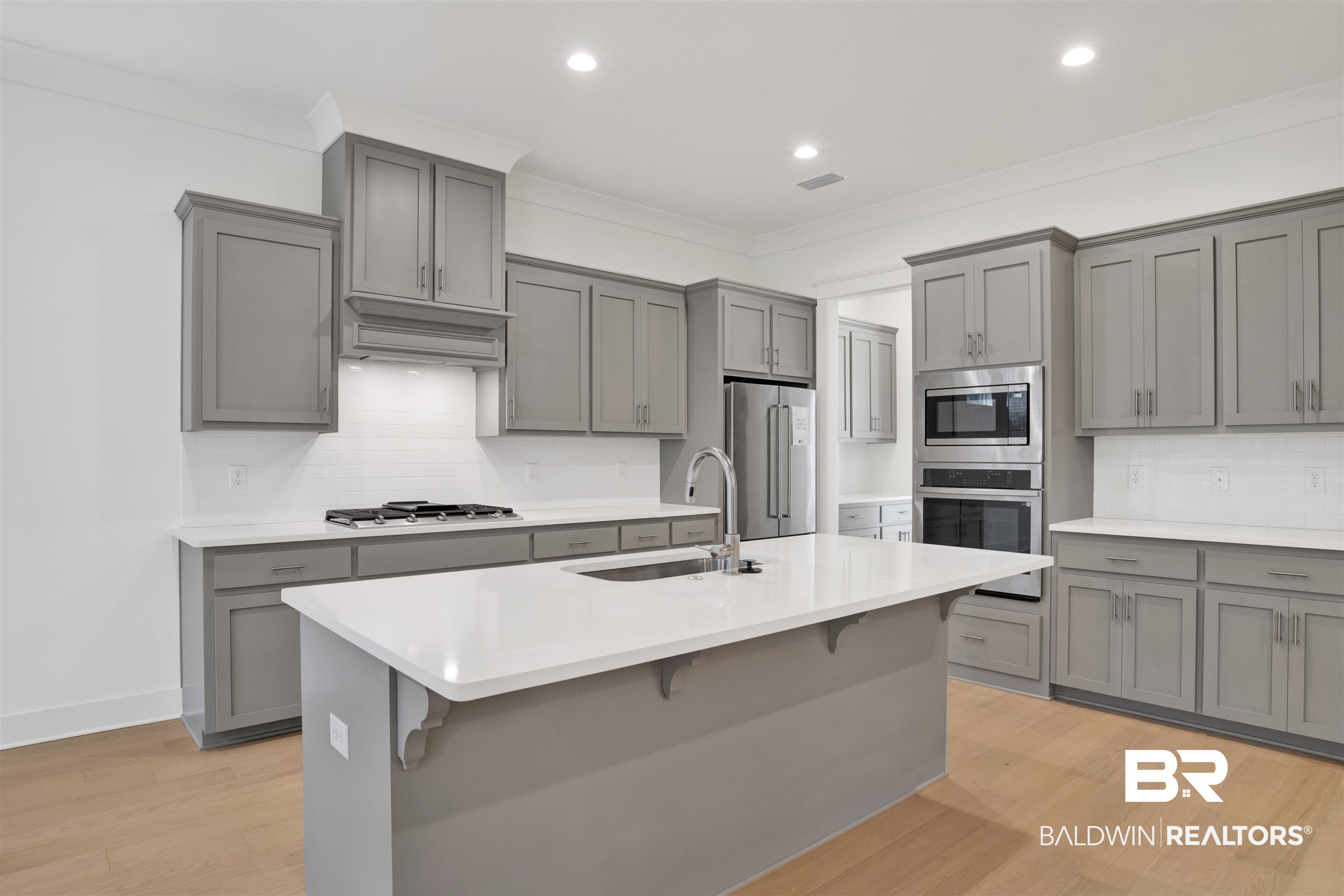 5 Long Leaf Circle Fairhope, AL 36532 - Photo 10 of 44 Kitchen featuring gray cabinets, stainless steel appliances, and light wood-type flooring