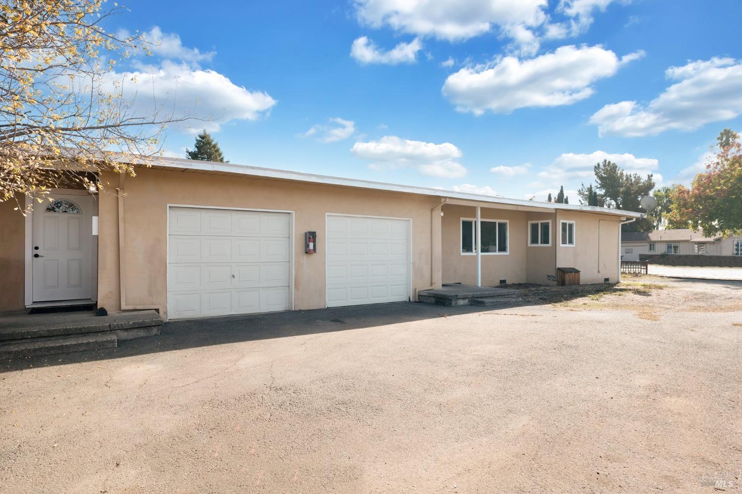 2583-2585 West Steele Lane Santa Rosa, CA 95403 - Photo 1 of 1 a view of a house with a yard