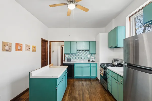 a kitchen with a refrigerator and a sink