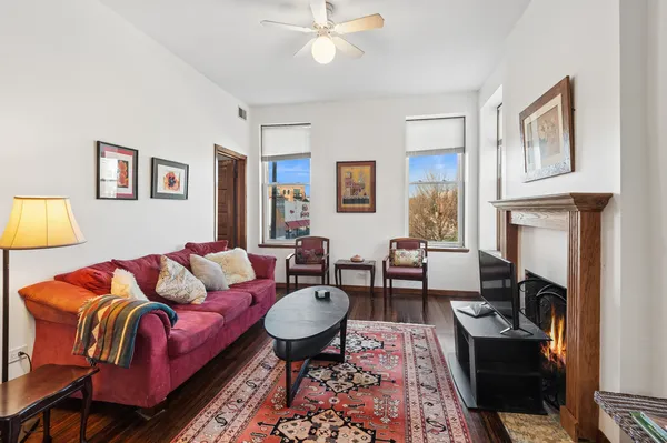 a living room with furniture fireplace and a window