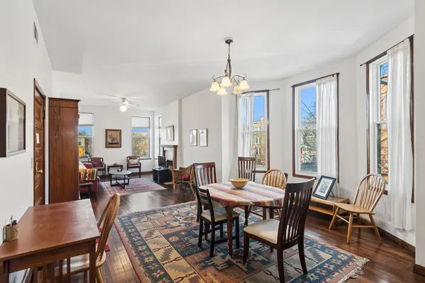 a view of a dining room with furniture window and wooden floor