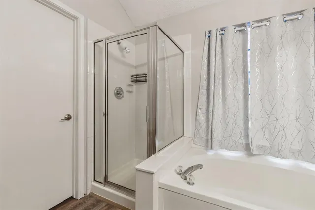 a bathroom with a shower and a tub