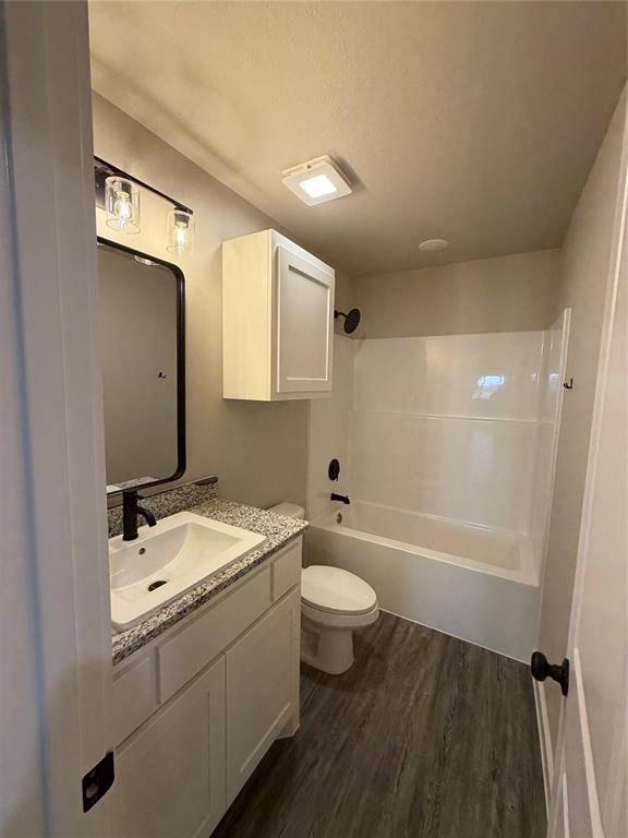 4209 Ranger Street Abilene, TX 79601 - Photo 13 of 20 a bathroom with a sink a toilet and bathtub