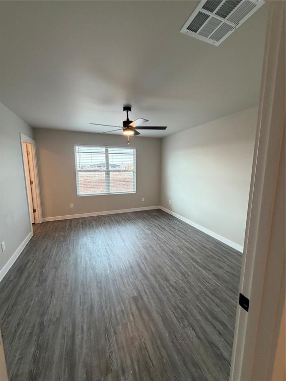 4209 Ranger Street Abilene, TX 79601 - Photo 17 of 20 an empty room with wooden floor and windows