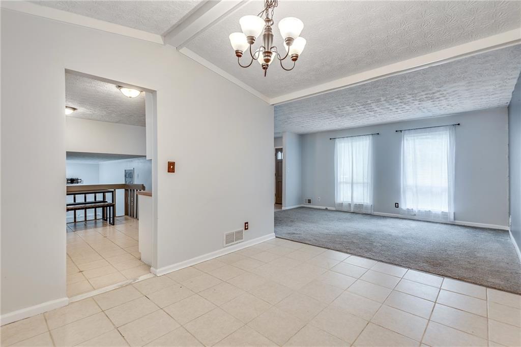 5611 Whittondale Road Lithonia, GA 30058 - Photo 7 of 34 a view of a livingroom with a dining table & chairs