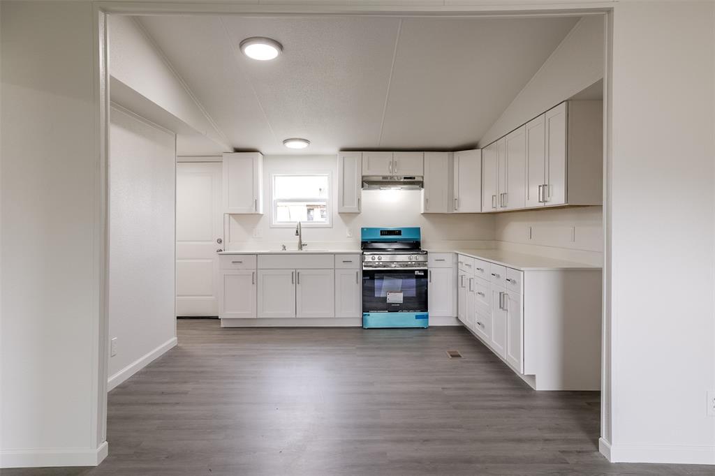 945 Walnut Street Azle, TX 76020 - Photo 12 of 29 a kitchen with stainless steel appliances a refrigerator sink and cabinets