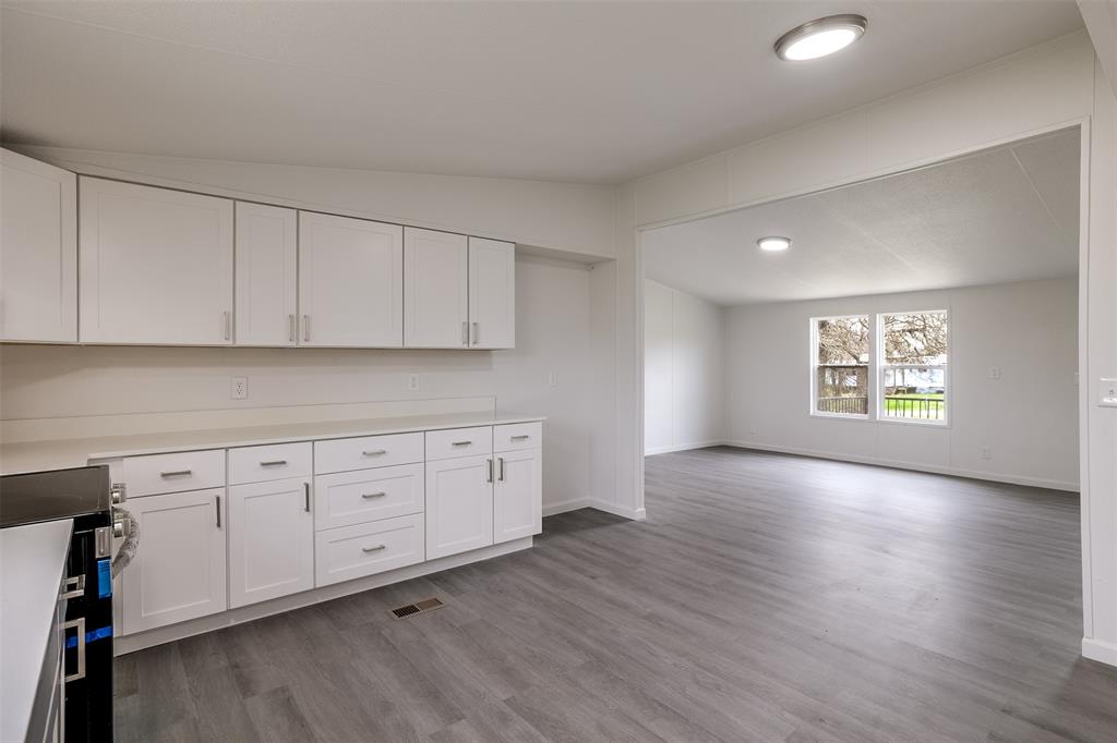 945 Walnut Street Azle, TX 76020 - Photo 14 of 29 a view of a kitchen with window and wooden floor