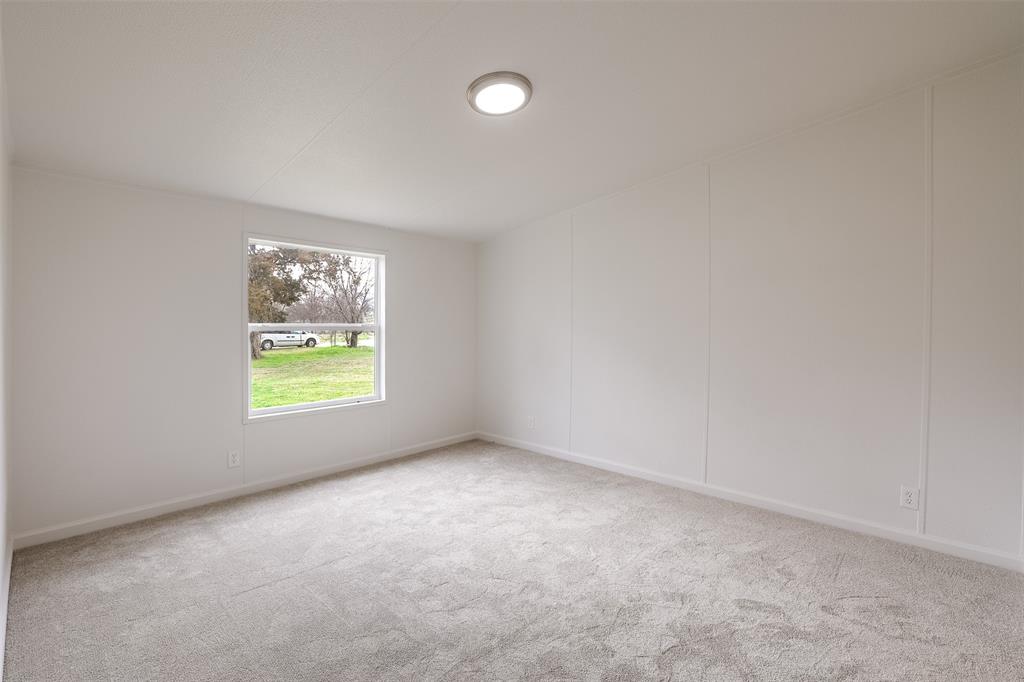 945 Walnut Street Azle, TX 76020 - Photo 16 of 29 a view of an empty room with a window