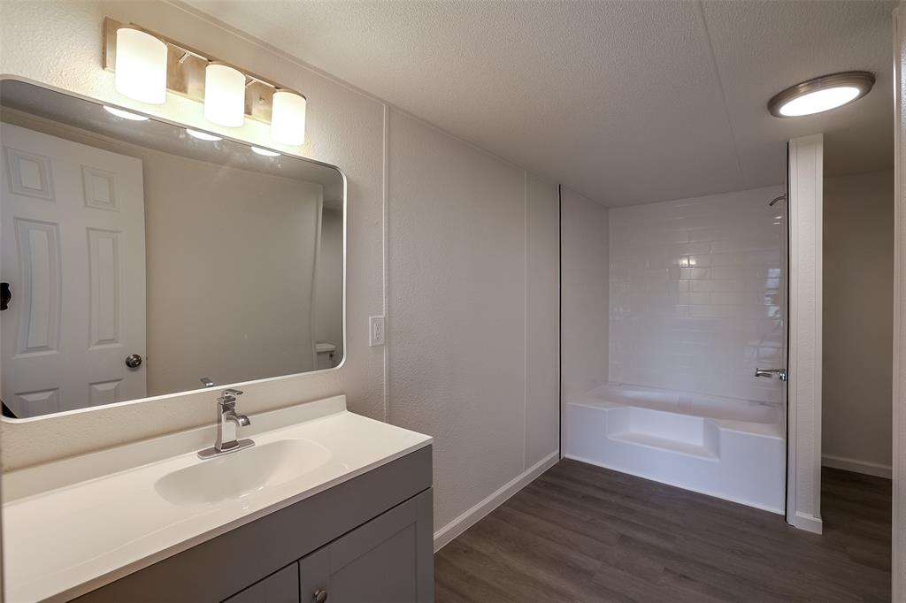 945 Walnut Street Azle, TX 76020 - Photo 17 of 29 a bathroom with a sink and a mirror