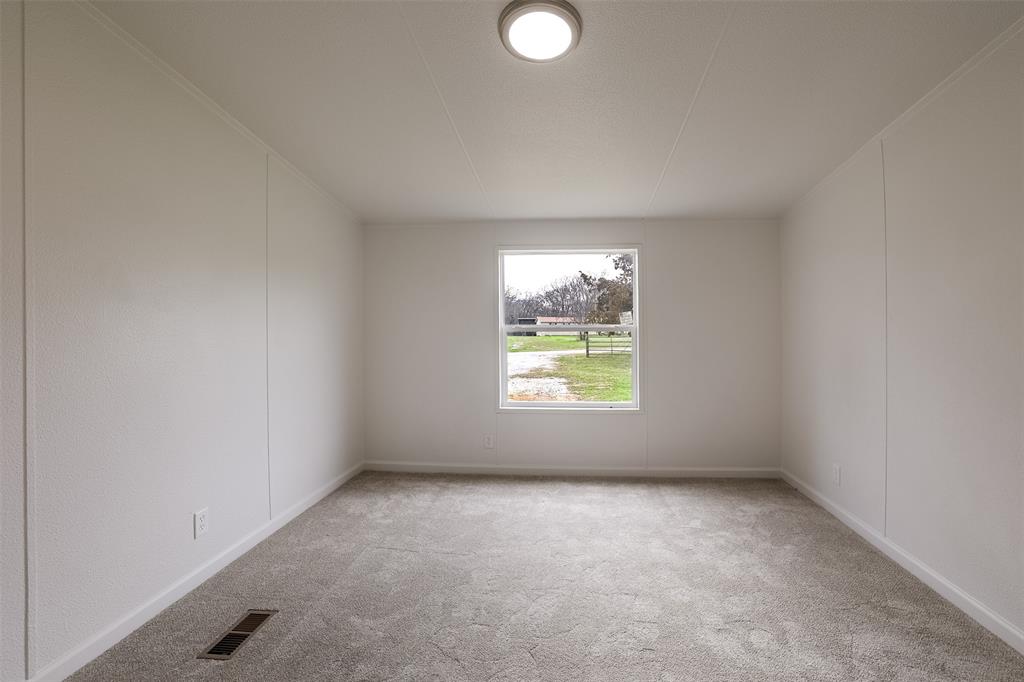 945 Walnut Street Azle, TX 76020 - Photo 18 of 29 an empty room with windows