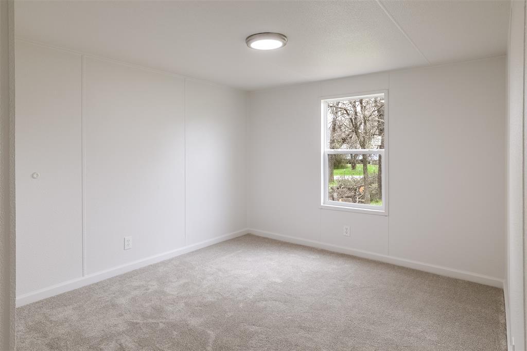 945 Walnut Street Azle, TX 76020 - Photo 19 of 29 an empty room with windows