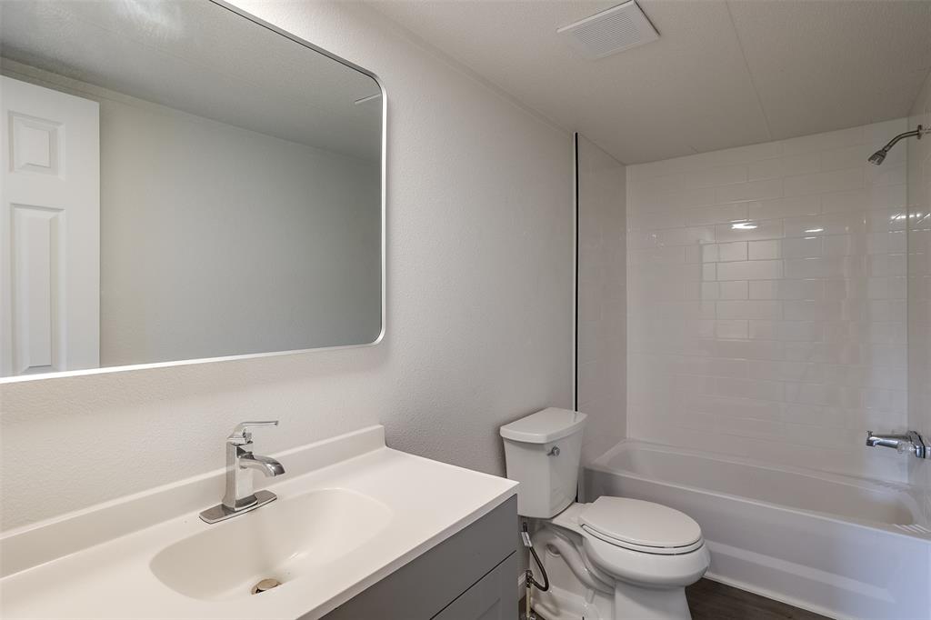 945 Walnut Street Azle, TX 76020 - Photo 20 of 29 a bathroom with a sink toilet and a mirror