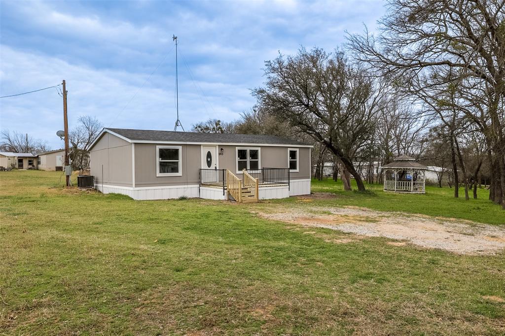 945 Walnut Street Azle, TX 76020 - Photo 2 of 29 a view of a house with a big yard
