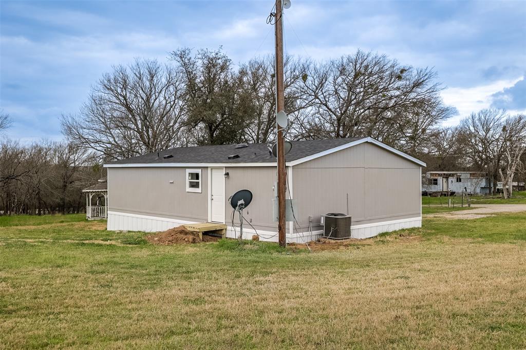 945 Walnut Street Azle, TX 76020 - Photo 26 of 29 a view of a house with backyard and trees