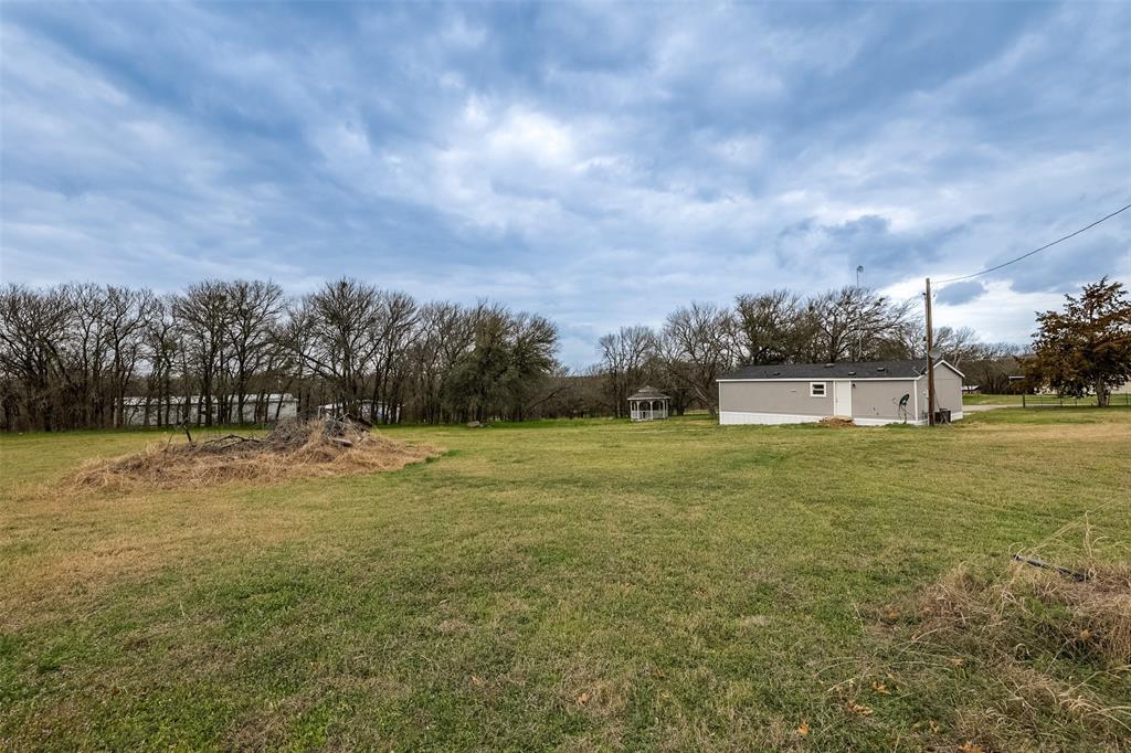 945 Walnut Street Azle, TX 76020 - Photo 28 of 29 a view of a big yard with a fountain
