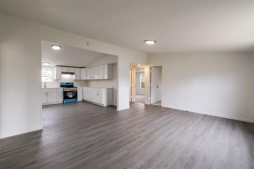 945 Walnut Street Azle, TX 76020 - Photo 8 of 29 a view of a kitchen with a sink and a refrigerator