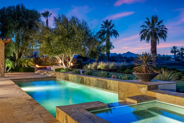 a view of a backyard with plants and swimming pool