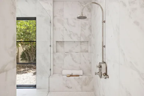 a bathroom with a tub sink and mirror