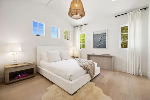 a living room with furniture a fireplace and a floor to ceiling window