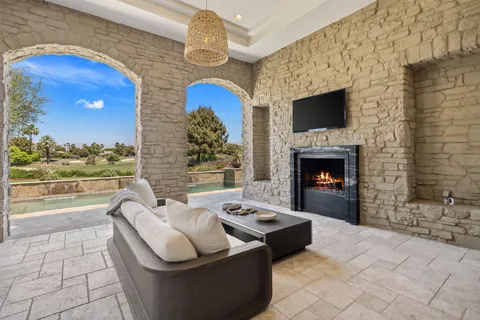 a view of a dining room with furniture and a chandelier