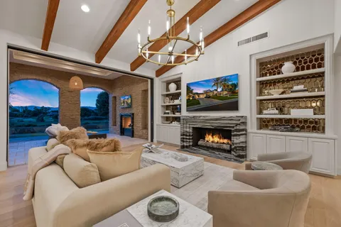 a view of swimming pool with a yard and palm trees