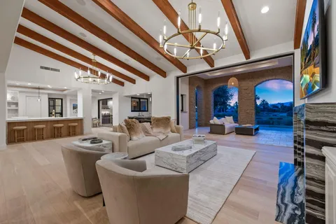 a view of a house with backyard and a tree