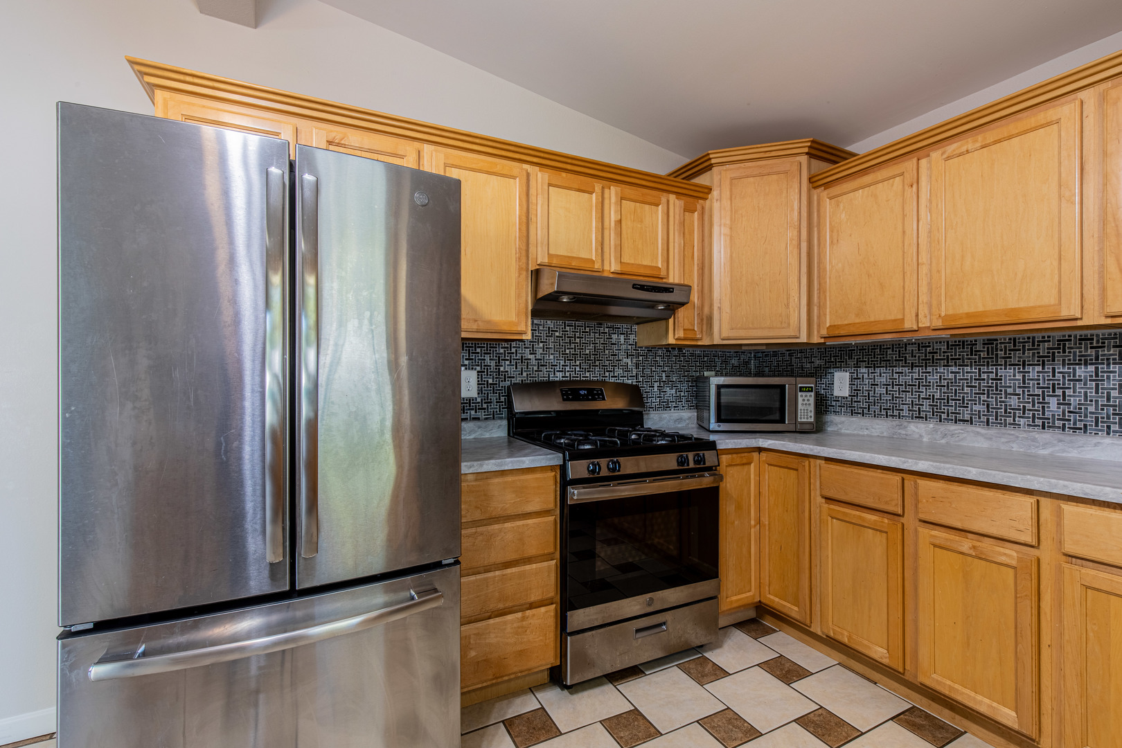1106 Beech Drive Dixon, IL 61021 - Photo 8 of 32 a kitchen with stainless steel appliances granite countertop a refrigerator and a stove top oven