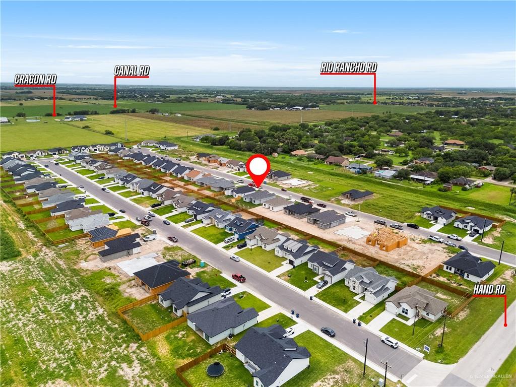 18054 Spruce Street Combes, TX 78552 - Photo 21 of 25 Aerial view of a residential development featuring single-story homes with dark shingle roofs, paved streets, and green landscaping
