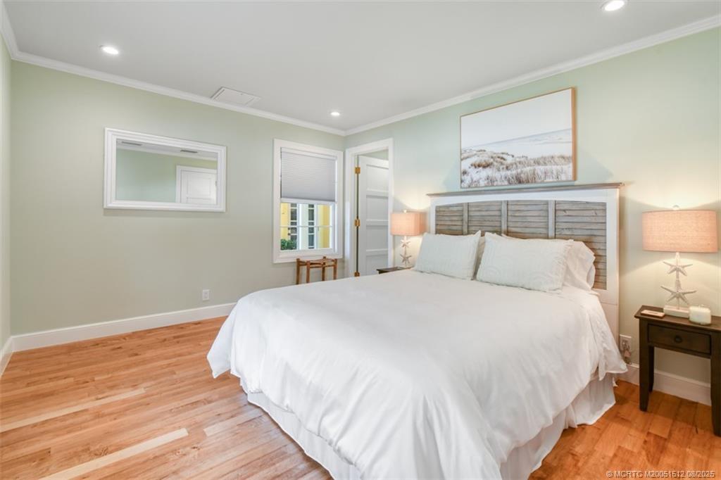 485 South Beach Road Hobe Sound, FL 33455 - Photo 18 of 72 a bedroom with a bed and a painting on the wall