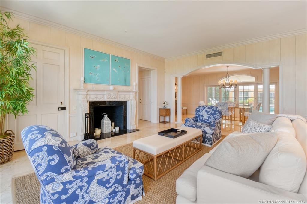 485 South Beach Road Hobe Sound, FL 33455 - Photo 24 of 72 a living room with furniture and a fireplace