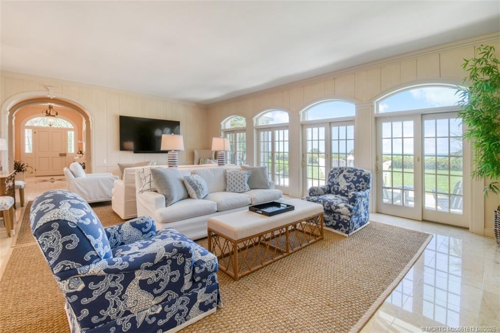 485 South Beach Road Hobe Sound, FL 33455 - Photo 25 of 72 a living room with furniture large window and a flat screen tv